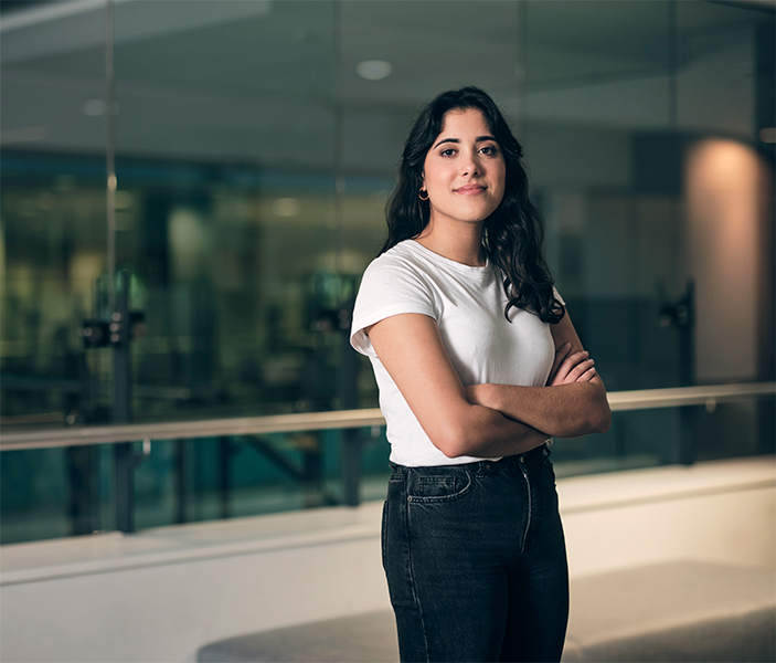 a woman wearing a white shirt folding her arms