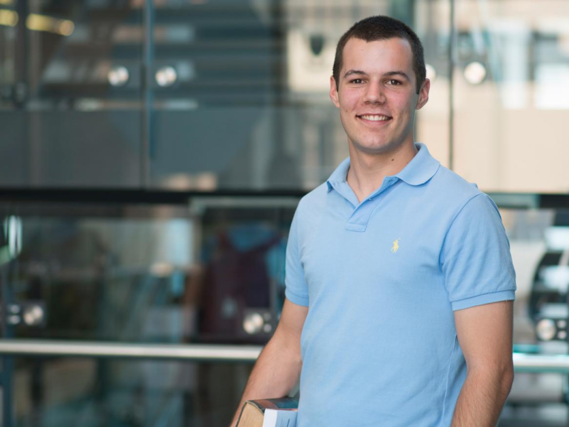Student standing in the health sciences building