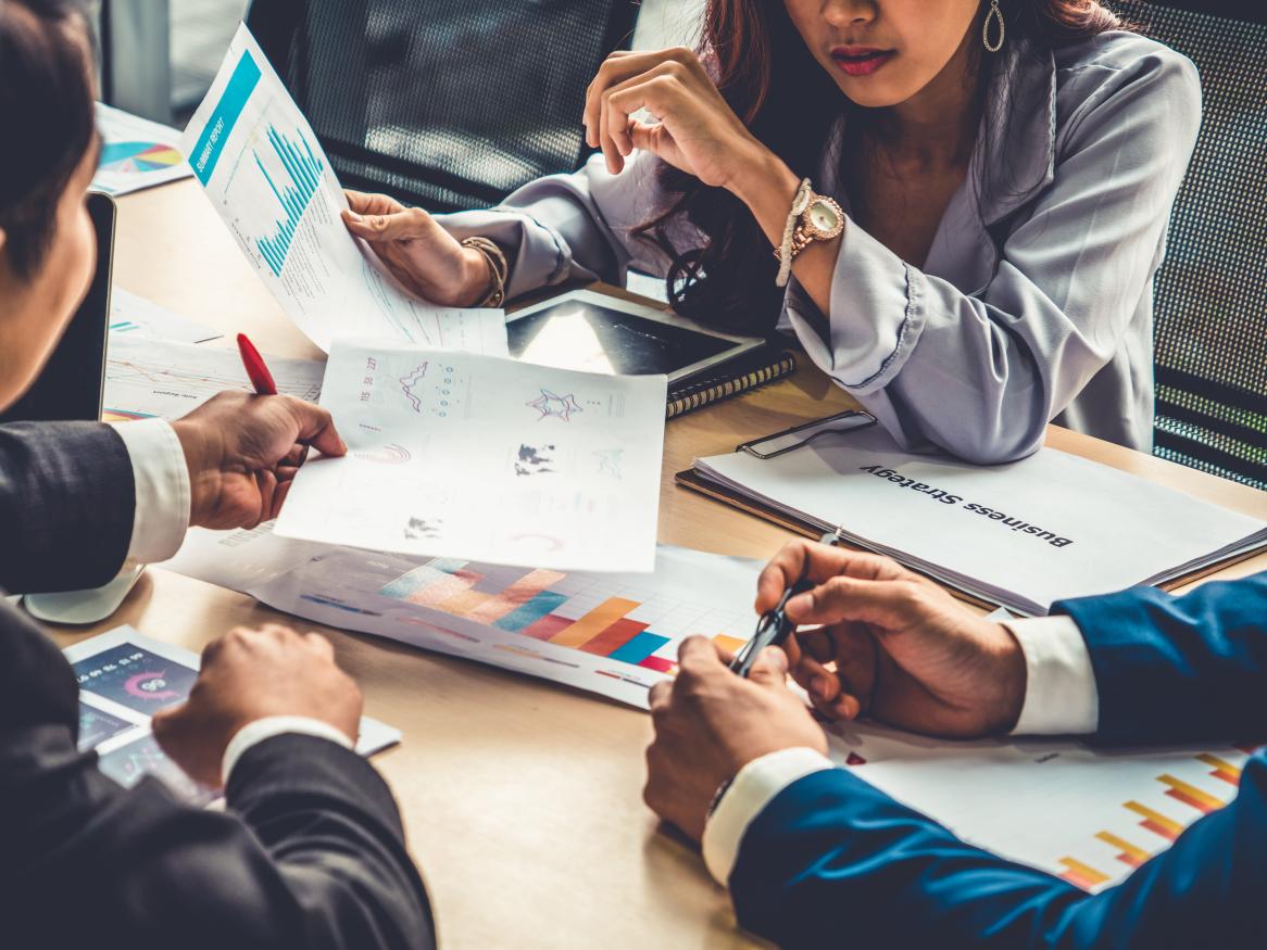 People meeting with computers and papers