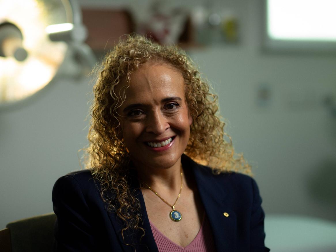 A portrait of Samantha in her surgery, smiling