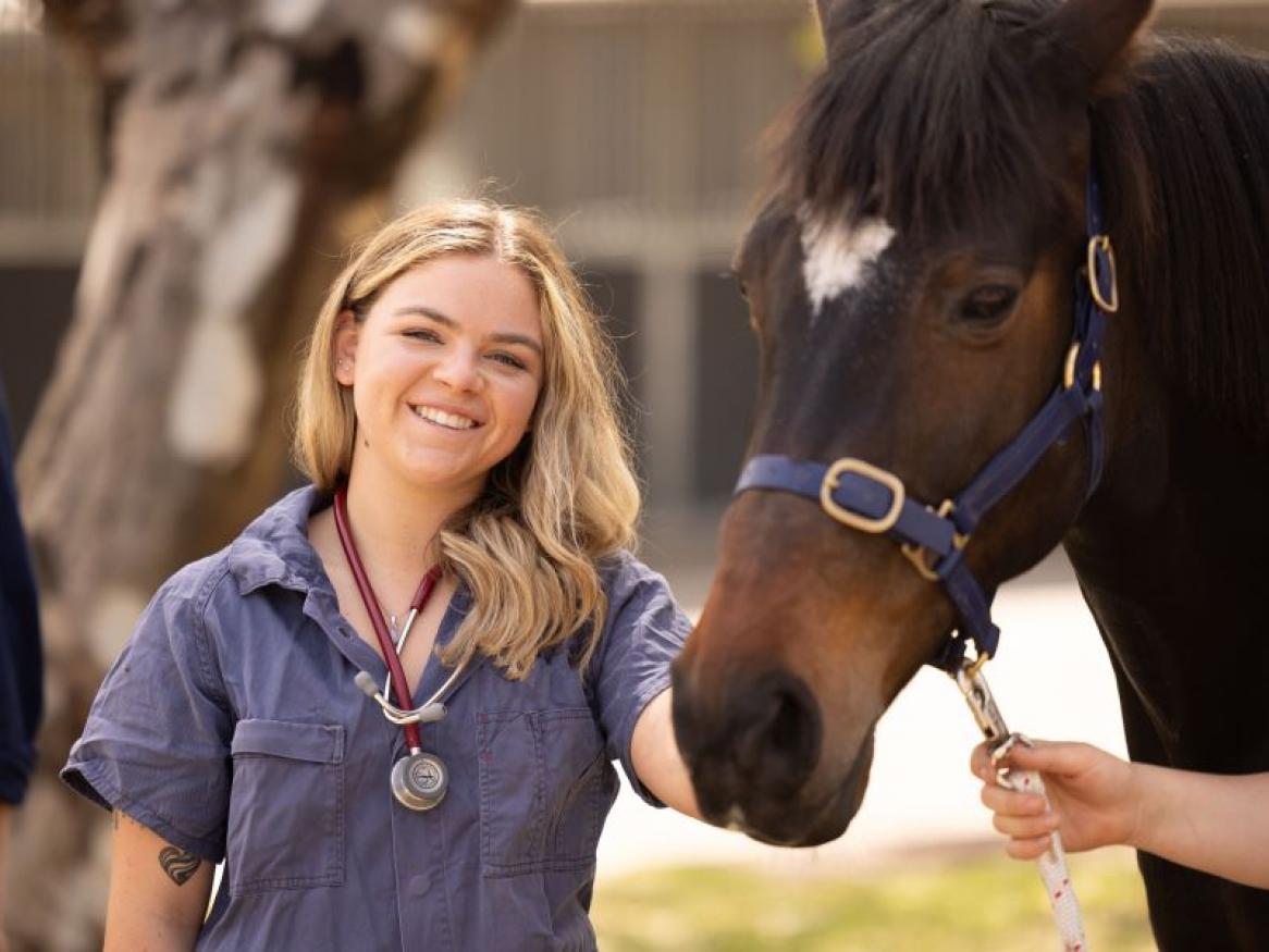 Student Lani holding School Horse Indi