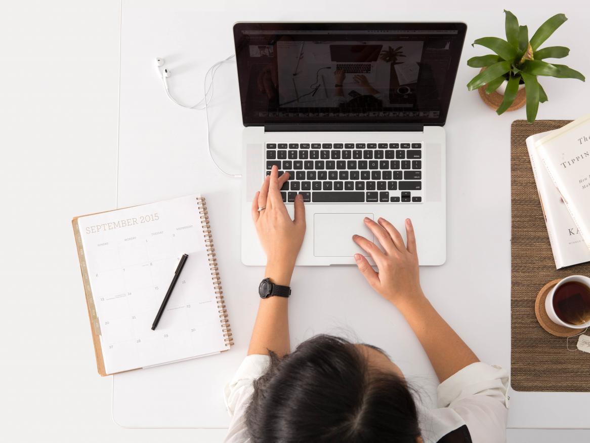 female sitting at a desk with laptop